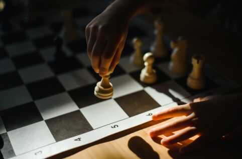 close up shot of a person playing chess