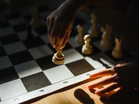 close up shot of a person playing chess