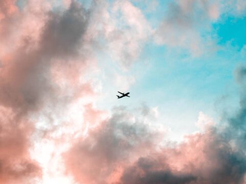 silhouette of airplane under cloudy sky